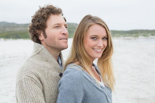 Side view portrait of a relaxed romantic young couple standing together at the beach