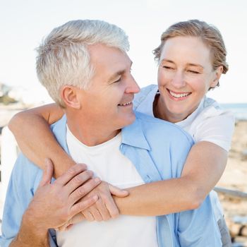 Casual couple having fun by the sea on a sunny day