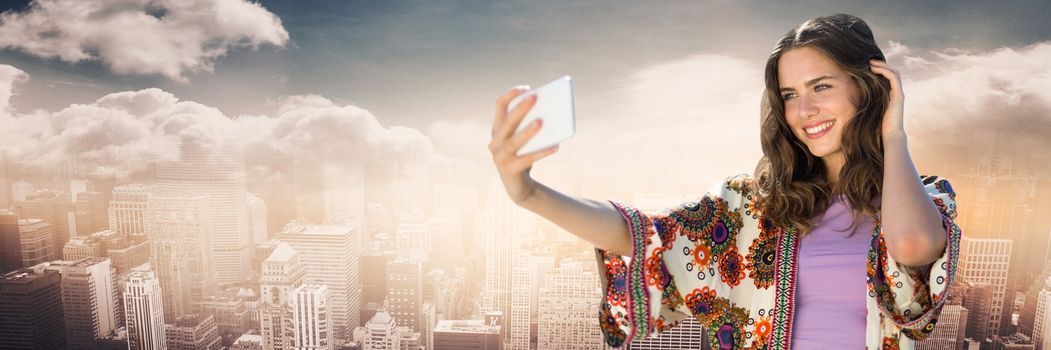 Digital composite of Millennial girl in summer clothes taking selfie against skyline with clouds