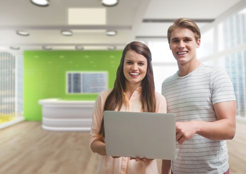 Digital composite of Happy business people holding a computer