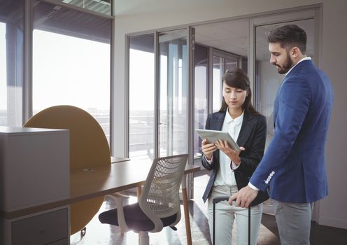 Digital composite of Business people looking at a tablet