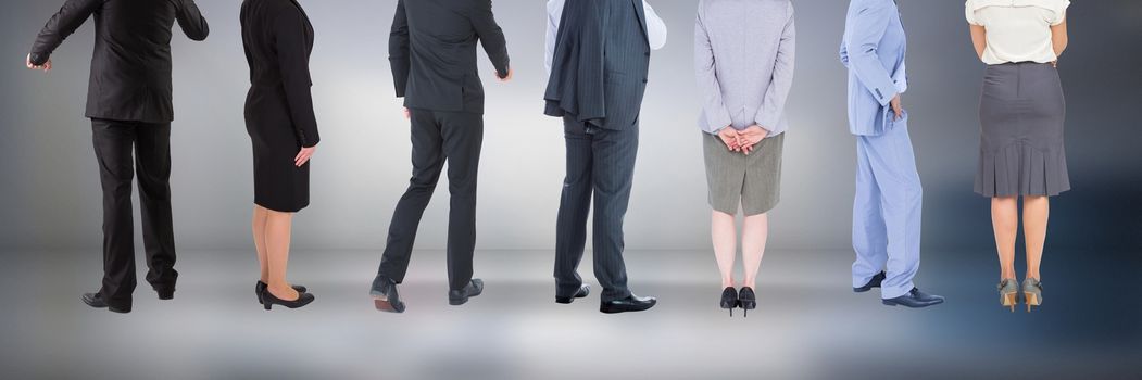 Digital composite of Group of Business People standing with moody background