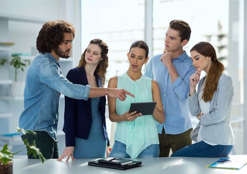 Digital composite of Business people at a desk talking