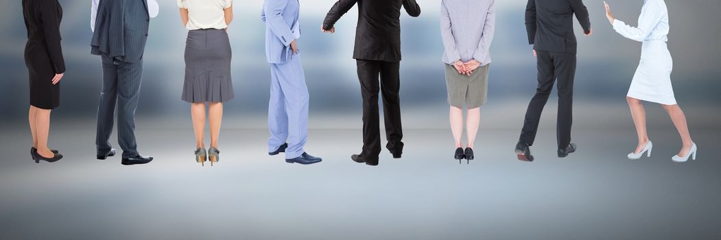 Digital composite of Group of Business People standing with moody background
