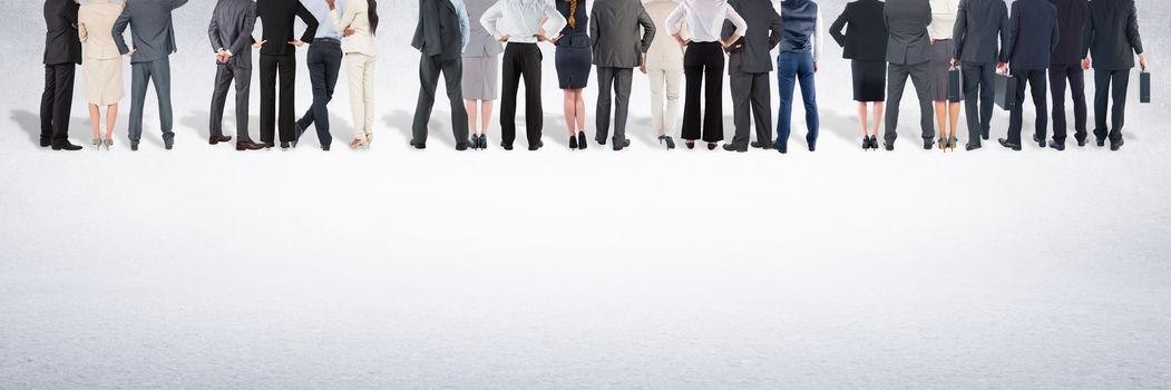 Digital composite of Group of business people standing in front of blank grey background