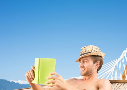 Digital composite of Man reading in hamoc against Summer sky