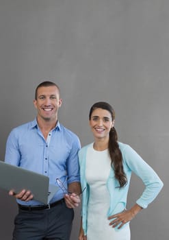 Digital composite of Happy business people holding a computer against grey background