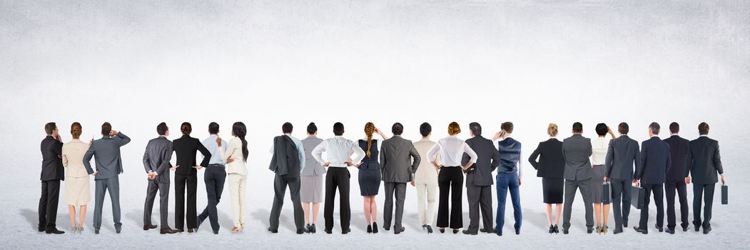 Digital composite of Group of business people standing in front of blank grey background