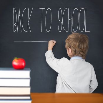 Cute pupil writing on board against back to school message