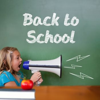 Back to school message against cute pupil shouting through megaphone