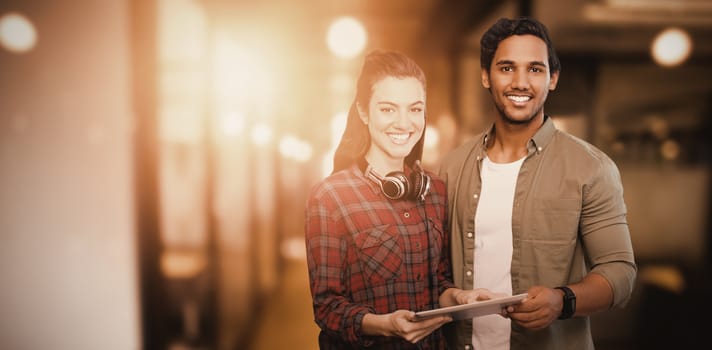 Portrait of people posing with digital tablet  against blur view of office corridor and workspace