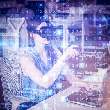 Businesswoman gesturing while wearing virtual reality simulator at office