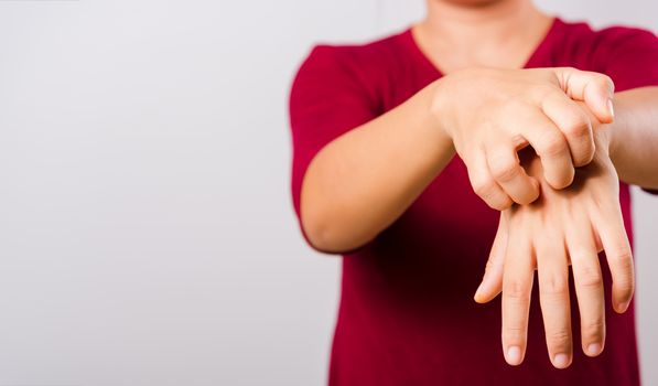 Asian beautiful woman itching her scratching her itchy arm on white background with copy space, Medical and Healthcare concept