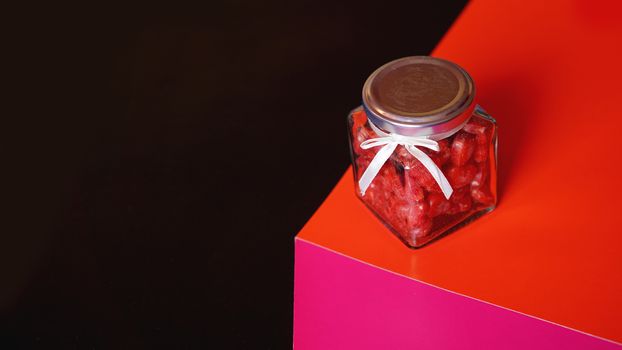 Valentine day and love concept. Hearts in jar with red and black background