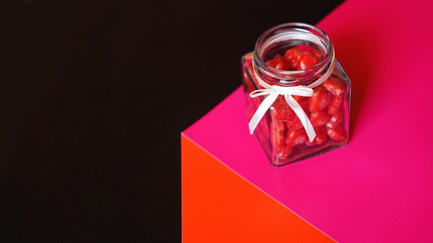 Valentine day and love concept. Hearts in jar with red and black background