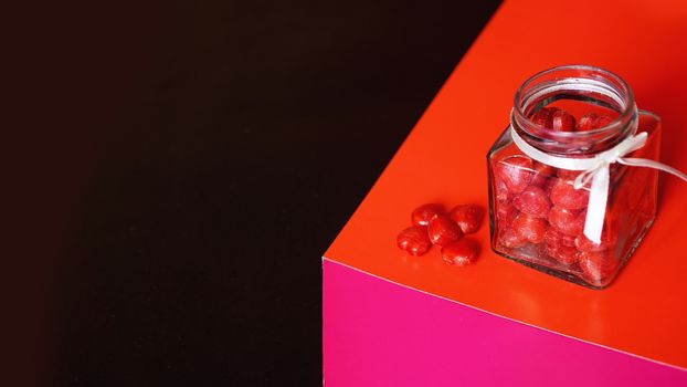 Valentine day and love concept. Hearts in jar with red and black background