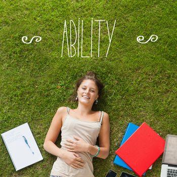 The word ability against pretty student lying on grass