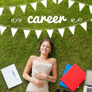 The word career and bunting against pretty student lying on grass