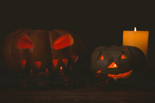 Illuminated jack o lantern with candles in darkroom during Halloween