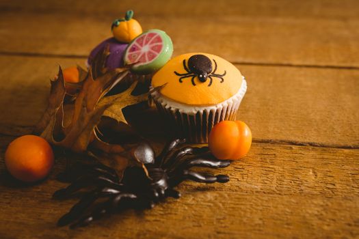 High angle view of Halloween decorations with cup cake on table