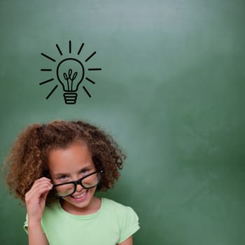 Cute pupil tilting glasses against idea and innovation graphic