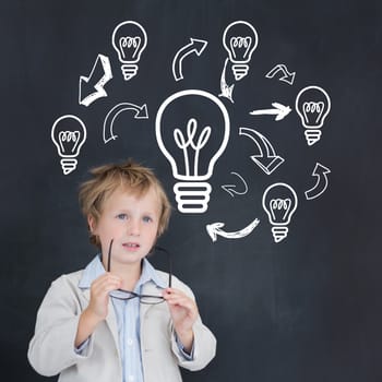 Cute pupil holding glasses against idea and innovation graphic