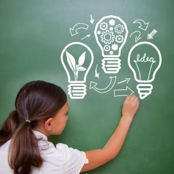 Idea and innovation graphic against cute pupil writing on chalkboard
