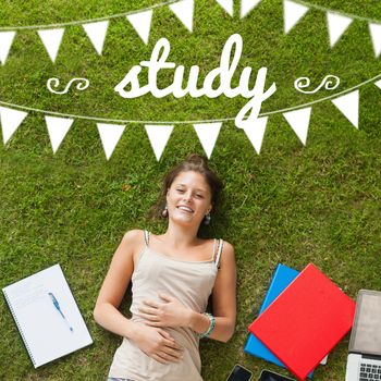 The word study and bunting against pretty student lying on grass