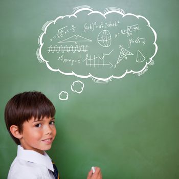 Math in thought bubble against cute pupil holding chalk