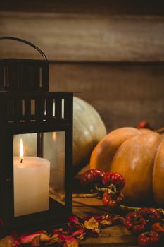 Pumpkins and burning candles on table during Halloween