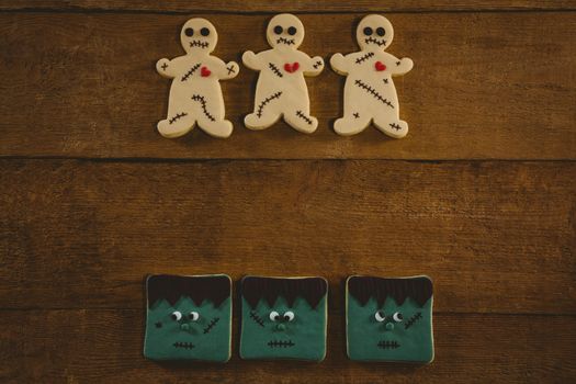 Overhead view of Halloween cookies arranged on wooden table