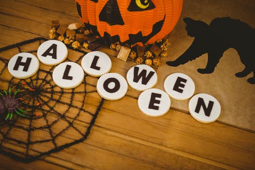 High angle view of cookies with Halloween text and decorations on table