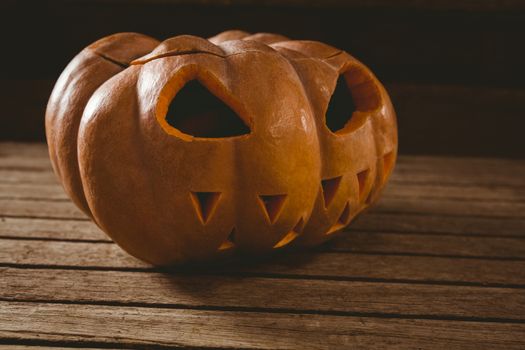 Close up of jack o lantern on wooden table during Halloween