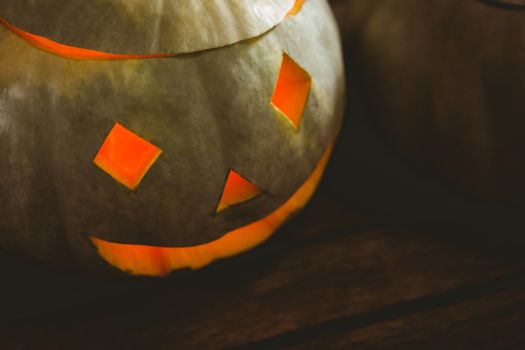 Close up of illuminated jack o lantern on table during Halloween