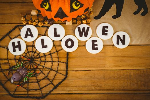 Overhead view of cookies with halloween text and decorations on table
