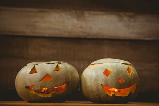 Close up of illuminated jack o lanterns on table during Halloween