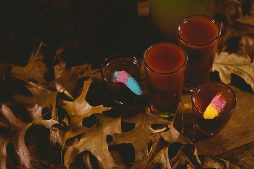 High angle view of drinks with autumn leaves on table during Halloween