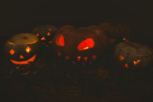 Illuminated jack o lanterns in darkroom during Halloween