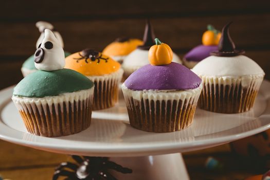 Close up of colorful cup cakes arranged on stand during Halloween