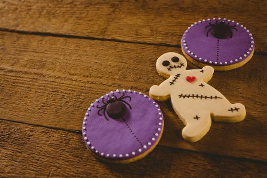 High angle view of Halloween cookies on wooden table 