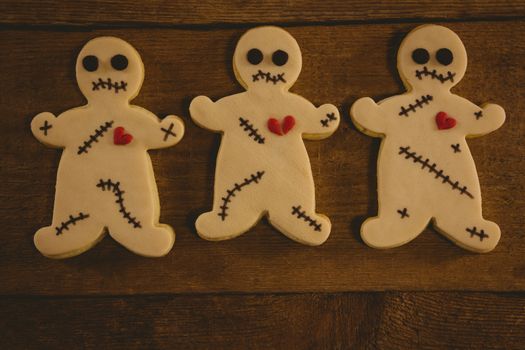 Overhead close up of Halloween cookies arranged on wooden table