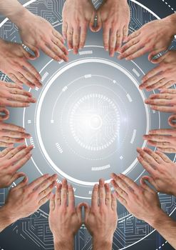 Digital composite of Hands in circle around technology interface