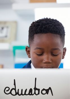 Digital composite of Education text against office kid boy using a computer background