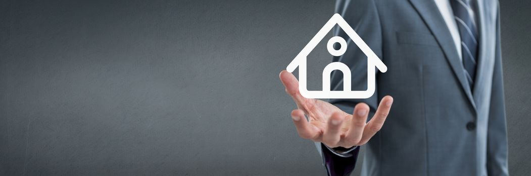 Digital composite of Hand holding a house icon as house insurance concept