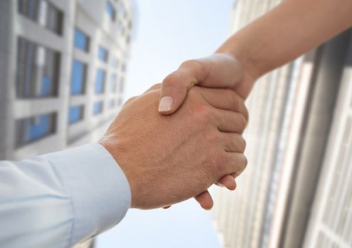 Digital composite of Business people shaking hands against city background