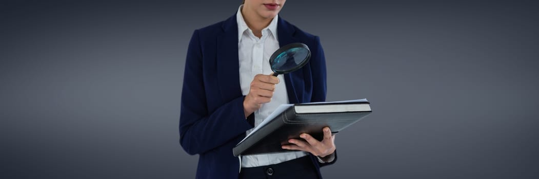 Digital composite of Woman with a magnifying glass against grey background as looking for an insurance concept