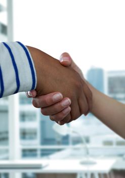 Digital composite of Business people shaking hands against office background