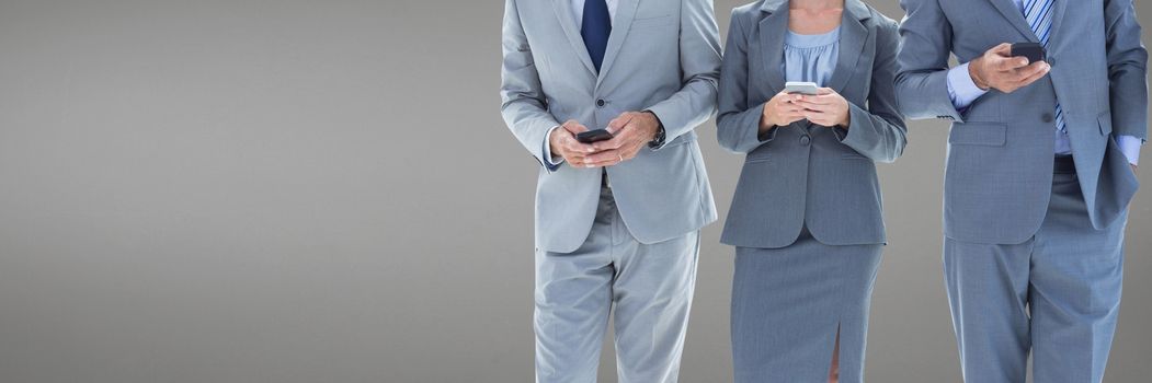 Digital composite of Business people using phones against grey background