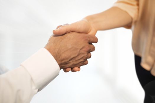 Digital composite of Business people shaking hands against white background