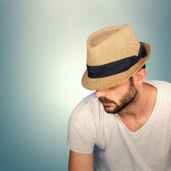 Handsome man wearing hat  against grey vignette